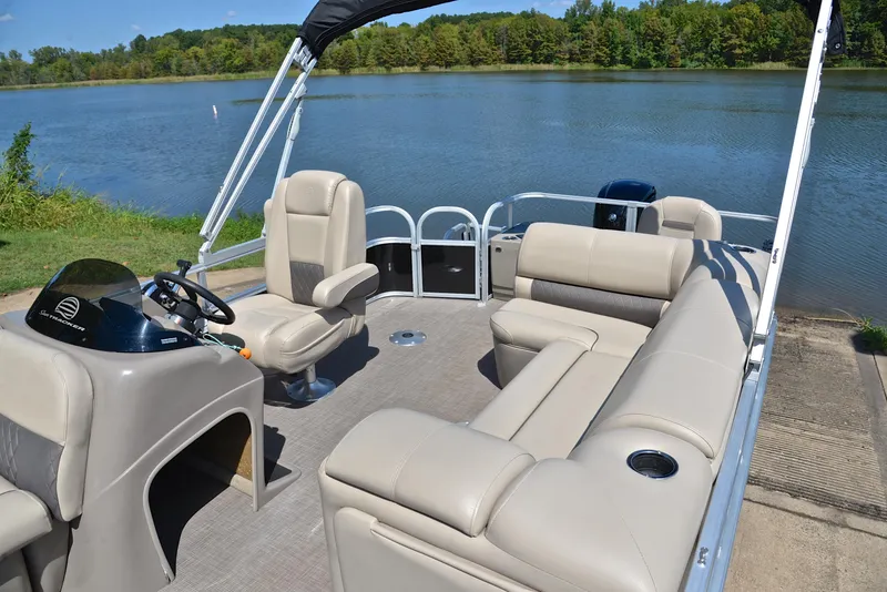 Slide: The Image of 2021 Sun Tracker Fishin Barge 20 DLX pontoon boat on a serene lake. - 23