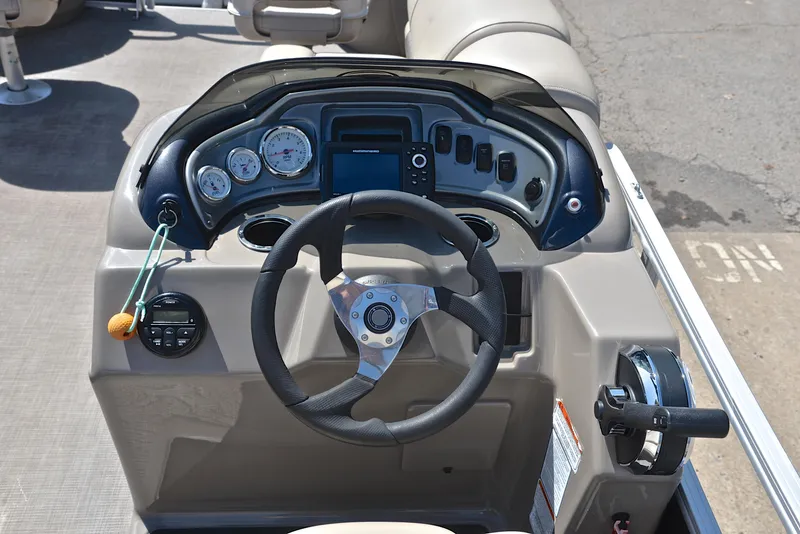 Slide: The Image of 2021 Sun Tracker Fishin Barge 20 DLX dashboard with steering wheel and controls. - 25