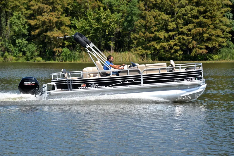 Slide: The Image of 2021 Sun Tracker Fishin Barge 20 DLX cruising on a serene lake. - 3