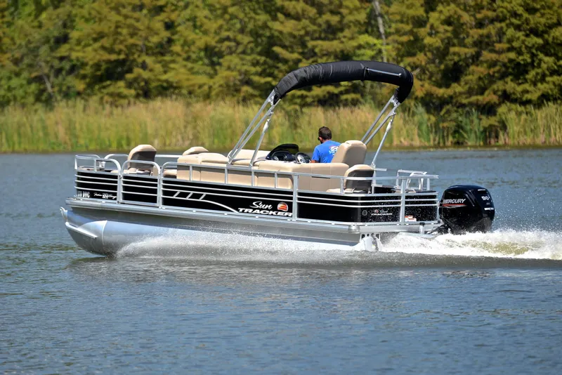 Slide: The Image of 2021 Sun Tracker Fishin Barge 20 DLX pontoon boat cruising on a lake. - 4
