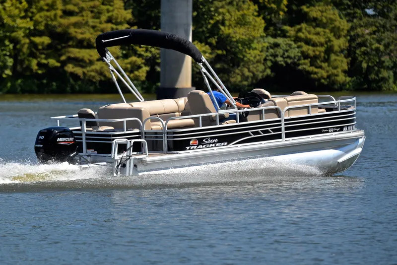 Slide: The Image of 2021 Sun Tracker Fishin Barge 20 DLX pontoon boat cruising on a lake. - 5