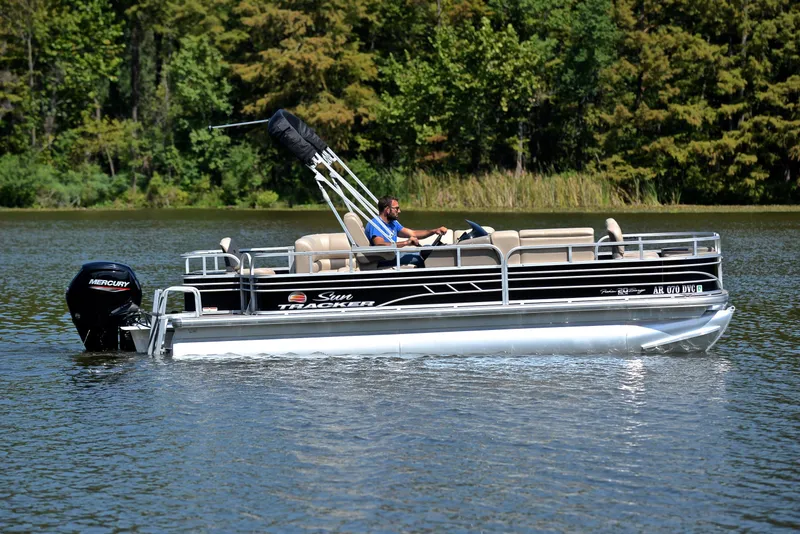 Slide: The Image of 2021 Sun Tracker Fishin Barge 20 DLX pontoon boat on a serene lake. - 6