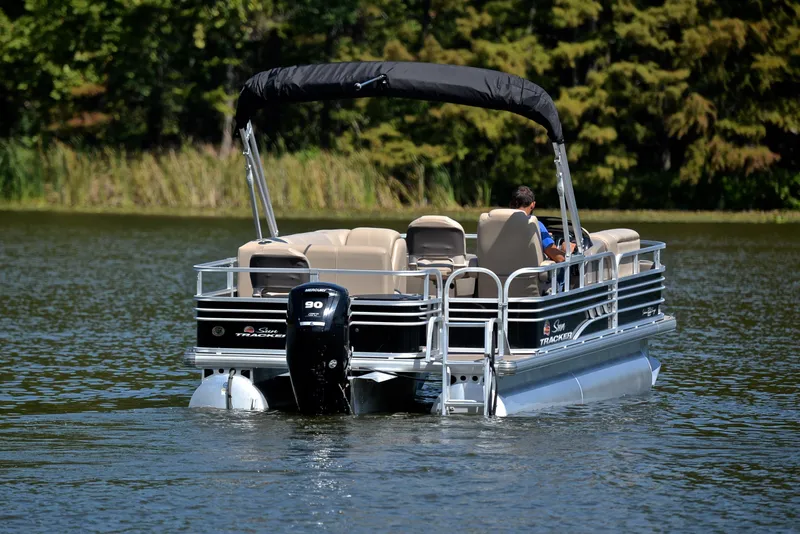 Slide: The Image of 2021 Sun Tracker Fishin Barge 20 DLX pontoon boat on a serene lake. - 7