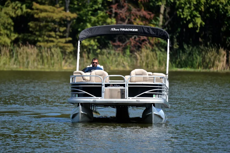 Slide: The Image of 2021 Sun Tracker Fishin Barge 20 DLX pontoon boat on a serene lake. - 8