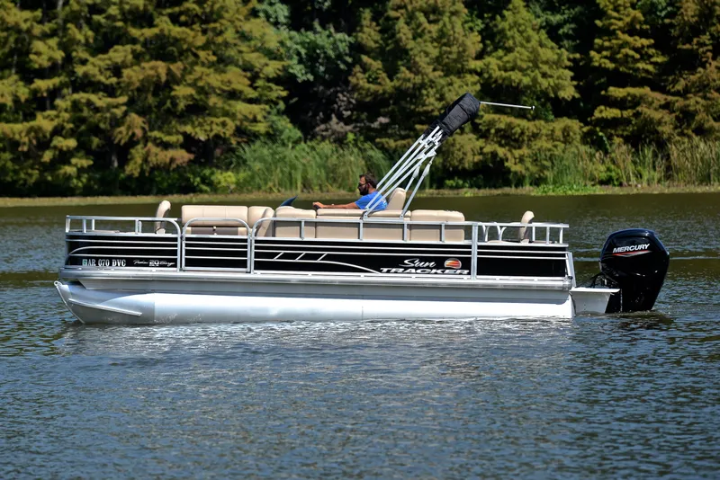 Slide: The Image of 2021 Sun Tracker Fishin Barge 20 DLX pontoon boat on a serene lake. - 9