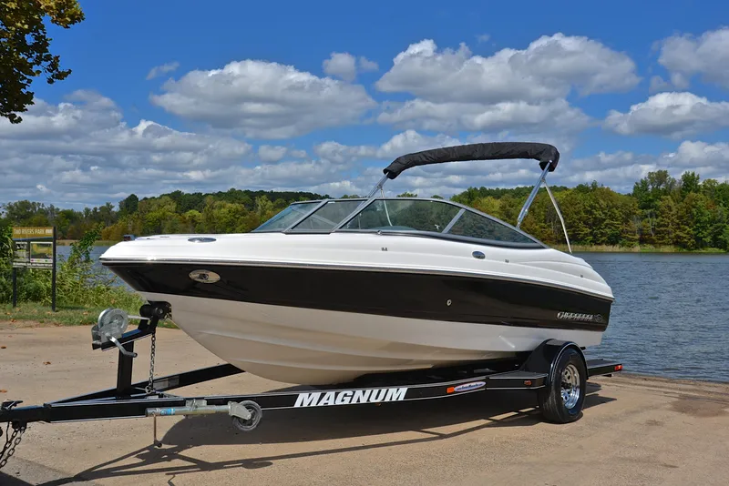 Slide: The Image of 2008 Chaparral 190 SSi boat on trailer by a lake under blue sky. - 10