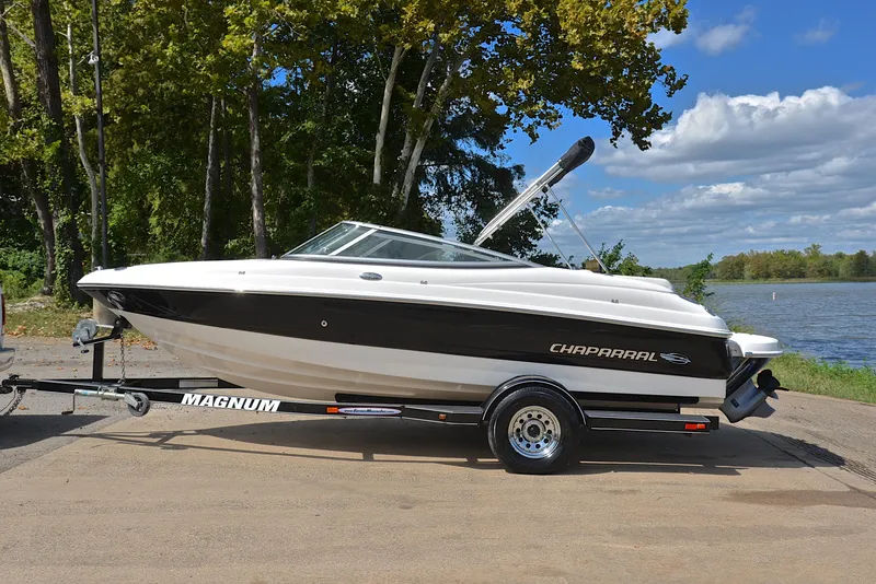 Slide: The Image of 2008 Chaparral 190 SSi boat on trailer by a lake, under clear skies. - 11