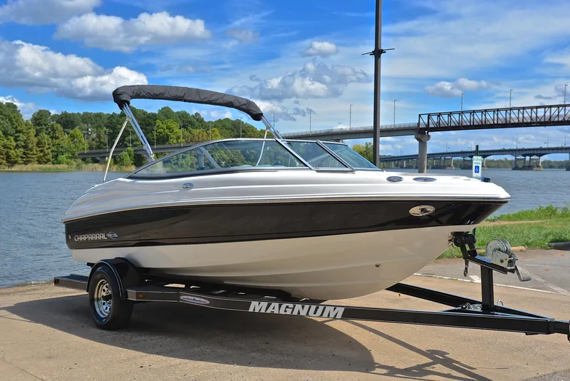 Slide: The Image of 2008 Chaparral 190 SSi boat on trailer by river, under blue sky. - 16