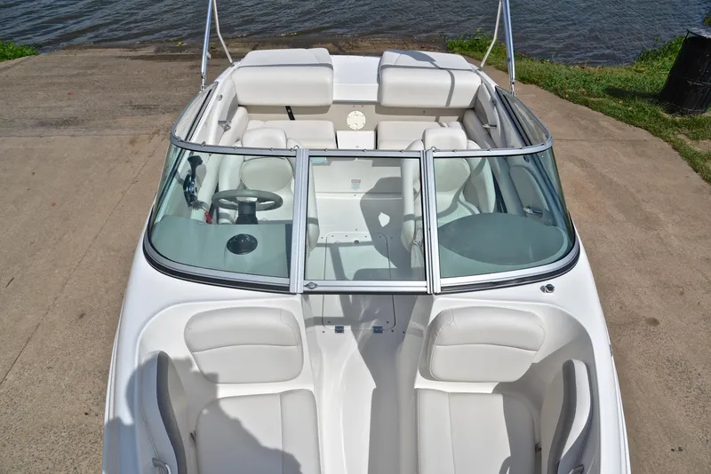 Slide: The Image of 2008 Chaparral 190 SSi boat with white interior, docked by the water. - 20