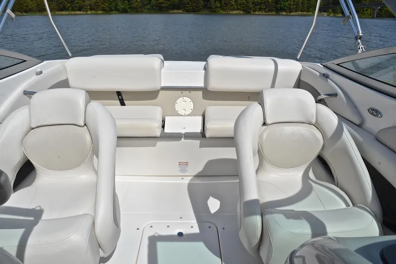 Slide: The Image of 2008 Chaparral 190 SSi boat interior with white leather seats on a calm lake. - 22