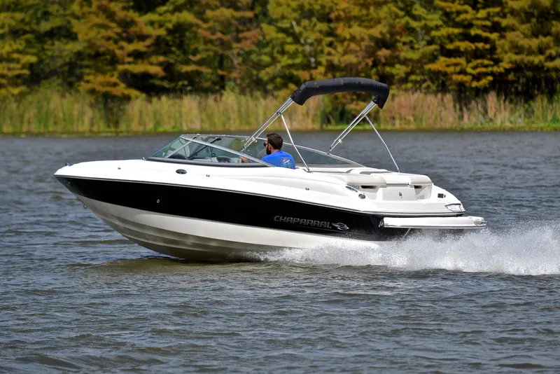 Slide: The Image of 2008 Chaparral 190 SSi speedboat cruising on a lake with lush greenery. - 4