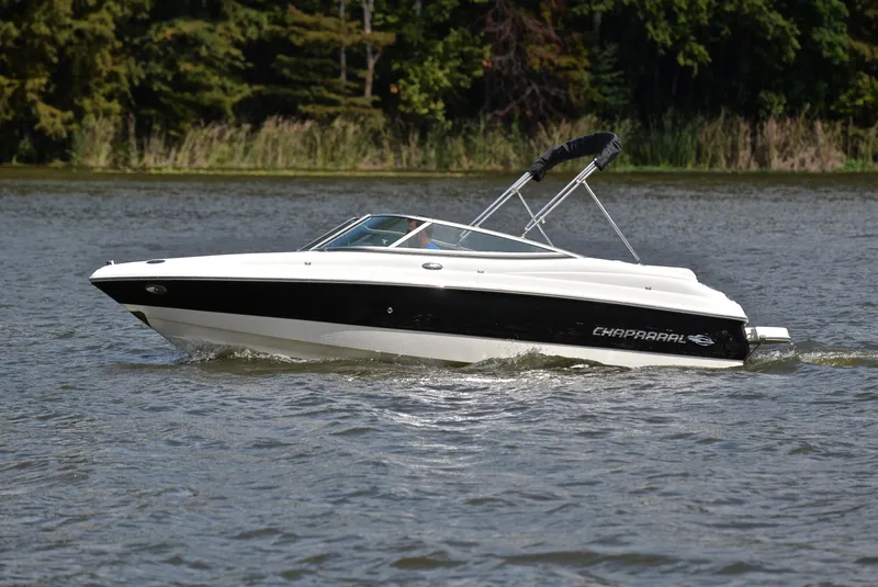 Slide: The Image of 2008 Chaparral 190 SSi boat cruising on a lake with forested background. - 9