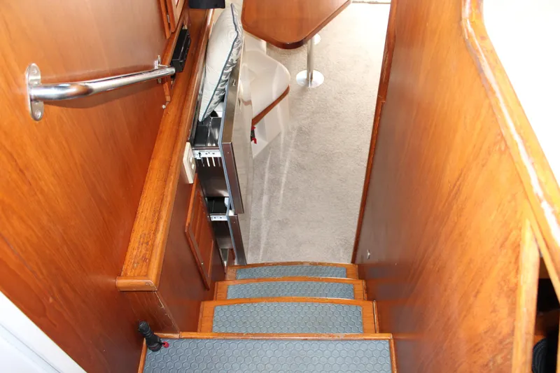 Slide: The Image of Staircase inside 2001 Nordhavn 40 yacht with wooden finish and carpeted steps. - 14