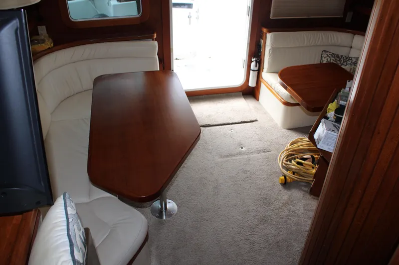 Slide: The Image of Interior of 2001 Nordhavn 40 yacht with wooden table and white seating. - 16
