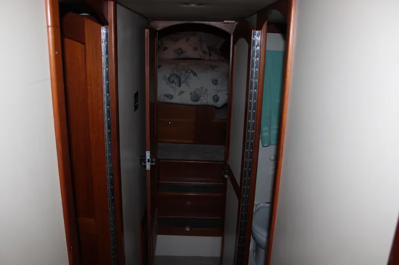 Slide: The Image of Interior hallway of 2001 Nordhavn 40 yacht with wooden finishes and cozy cabin. - 17