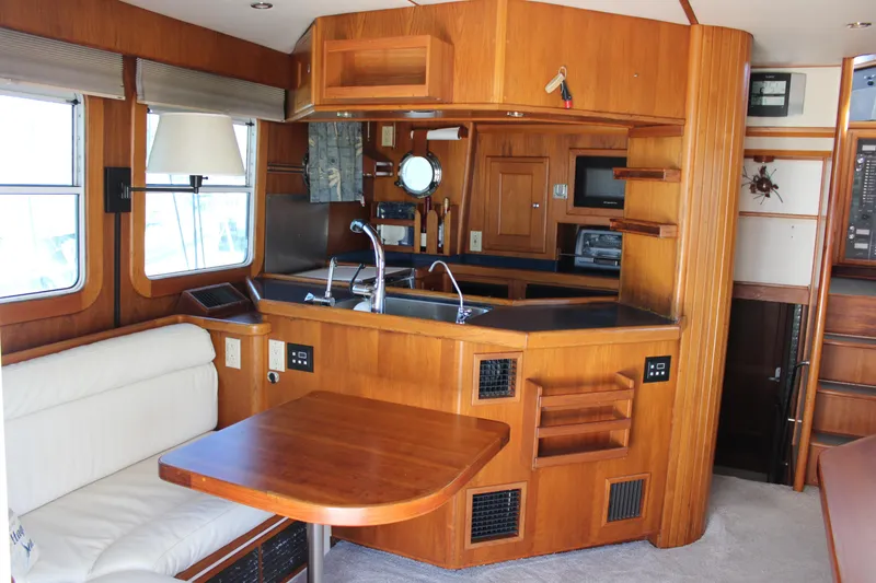 Slide: The Image of Interior of 2001 Nordhavn 40 yacht with wooden cabinetry and dining area. - 2