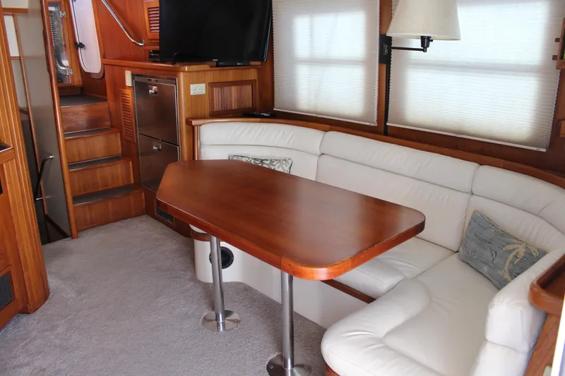 Slide: The Image of Luxurious 2001 Nordhavn 40 yacht interior with white seating and wooden table. - 3