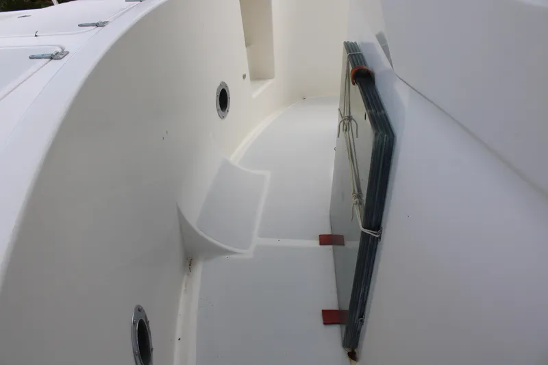 Slide: The Image of Nordhavn 40 yacht deck, 2001 model, featuring clean white surfaces and circular portholes. - 32