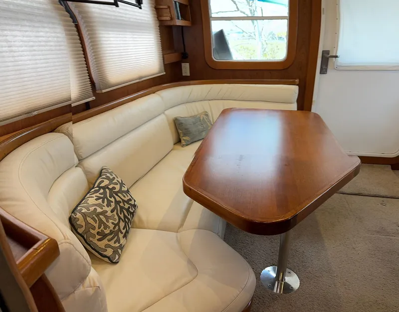 Slide: The Image of Cozy interior of 2001 Nordhavn 40 yacht with cushioned seating and wooden table. - 35