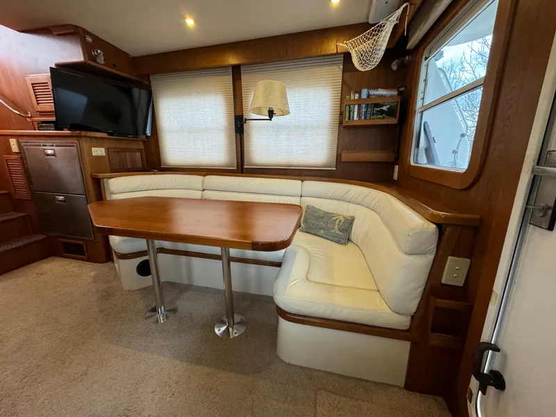 Slide: The Image of Interior of 2001 Nordhavn 40 yacht with cozy seating and wooden table. - 36