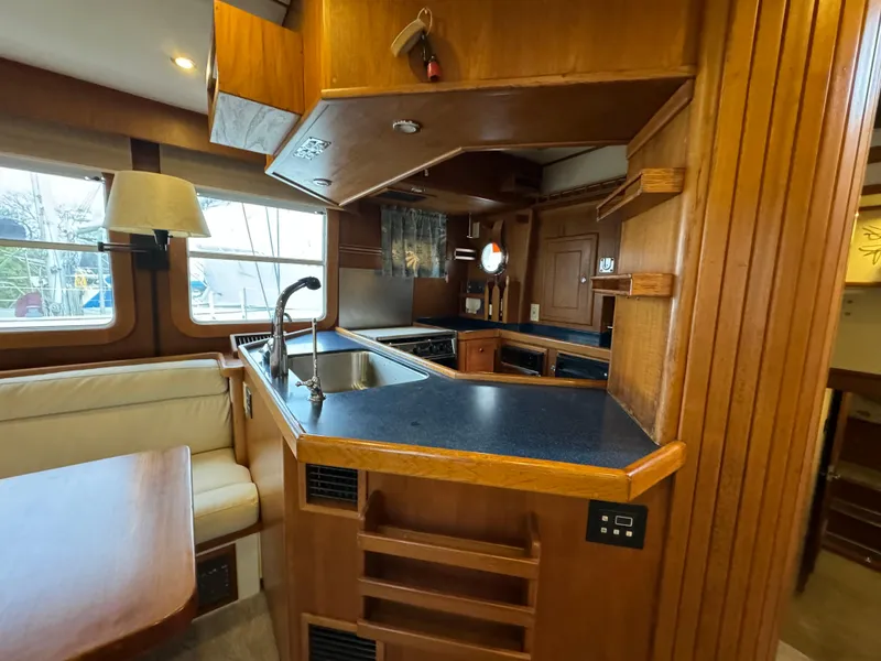 Slide: The Image of Luxurious 2001 Nordhavn 40 yacht interior with wood finish and modern kitchen amenities. - 38