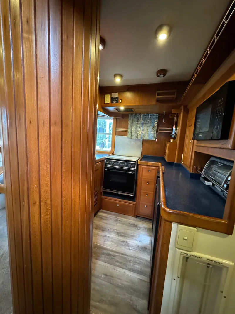Slide: The Image of Interior of 2001 Nordhavn 40 yacht with wooden cabinetry and modern kitchen appliances. - 39