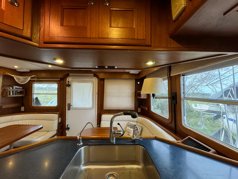 Slide: The Image of Interior of 2001 Nordhavn 40 yacht with wood cabinetry and cozy seating area. - 40