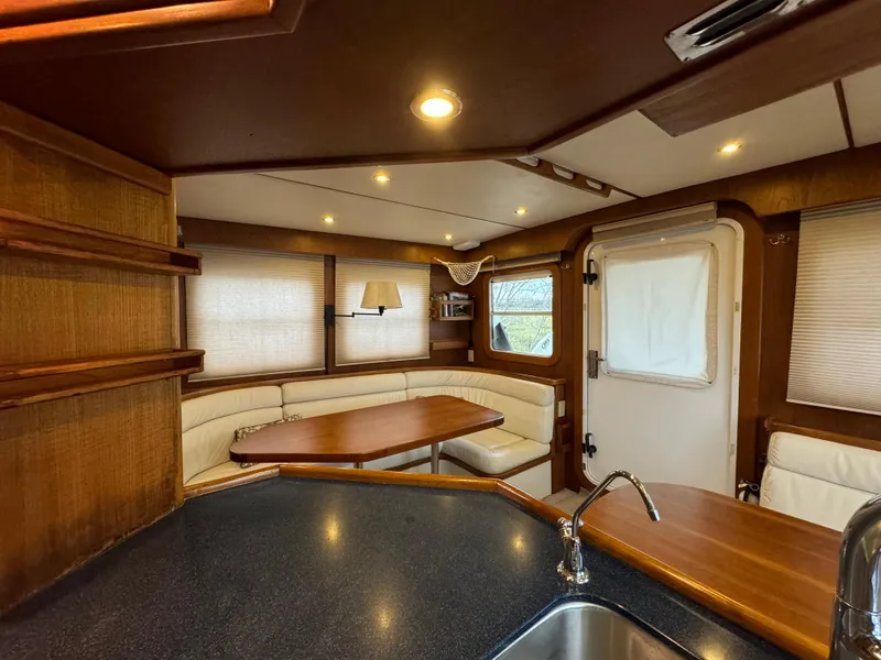 Slide: The Image of Interior of 2001 Nordhavn 40 yacht with cozy seating and wooden finishes. - 41