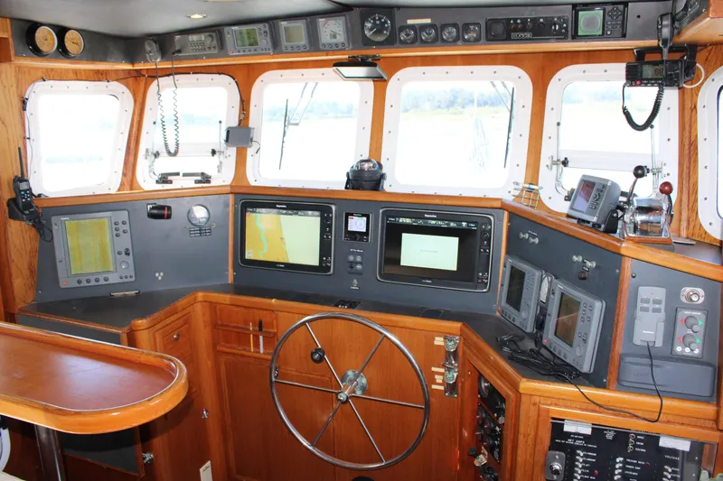 Slide: The Image of Interior of 2001 Nordhavn 40 yacht cockpit with navigation equipment and steering wheel. - 43