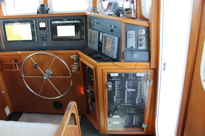Slide: The Image of 2001 Nordhavn 40 yacht helm with navigation equipment and control panel. - 44