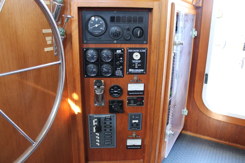 Slide: The Image of Control panel of a 2001 Nordhavn 40 yacht with gauges and switches. - 49