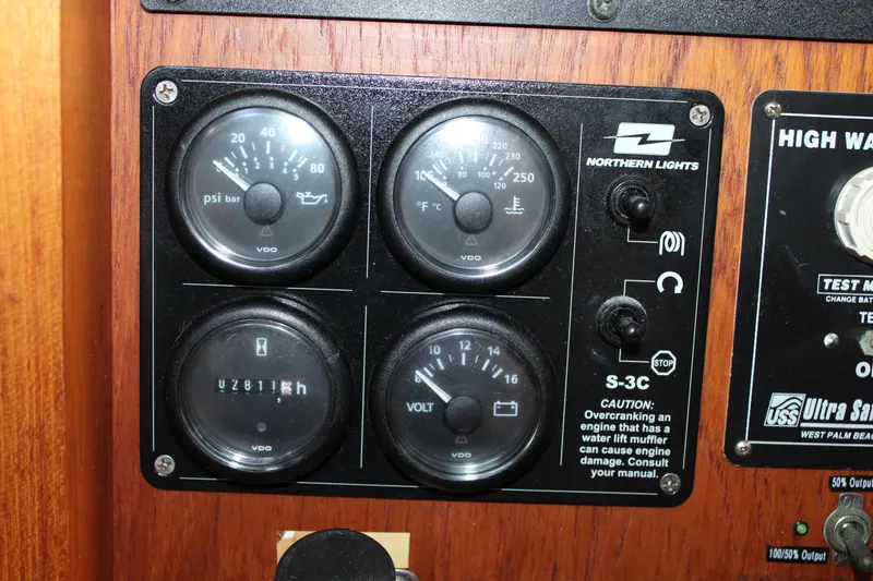 Slide: The Image of Control panel of a 2001 Nordhavn 40 boat with gauges and warning labels. - 7
