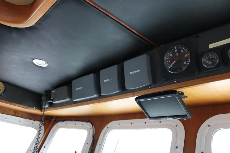 Slide: The Image of Navigation equipment inside 2001 Nordhavn 40 boat cockpit, featuring Raytheon displays and gauges. - 9