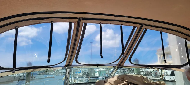 Slide: The Image of View from inside a 2000 Sea Ray 380 Sundancer, showcasing marina and blue sky. - 37