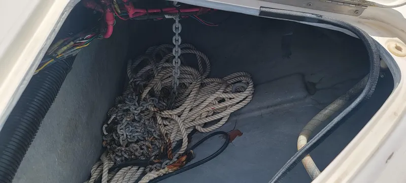 Slide: The Image of Anchor storage compartment of 2000 Sea Ray 380 Sundancer with ropes and chains. - 38