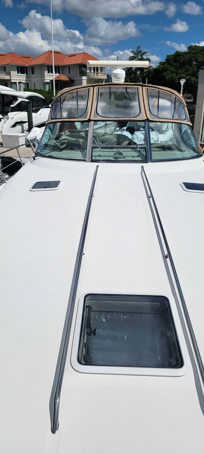 Slide: The Image of 2000 Sea Ray 380 Sundancer yacht docked under a clear blue sky. - 42