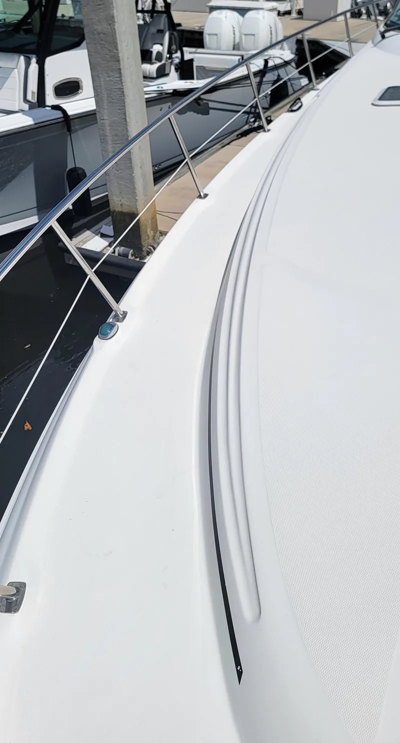 Slide: The Image of 2000 Sea Ray 380 Sundancer boat deck with railing in marina. - 43
