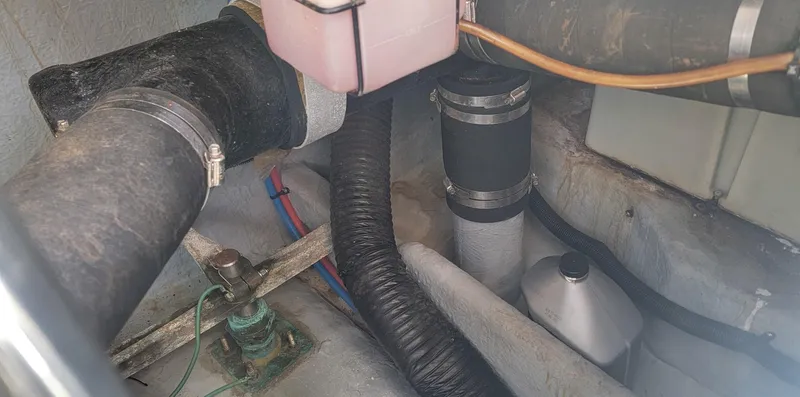 Slide: The Image of Engine compartment of 2000 Sea Ray 380 Sundancer with hoses and components. - 9