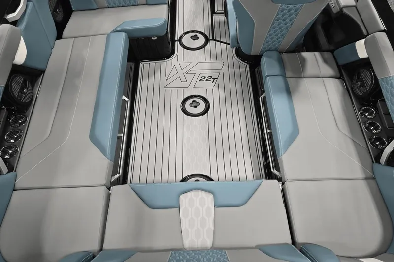 Slide: The Image of 2025 MasterCraft XT22 T boat interior with sleek gray and blue seating design. - 13