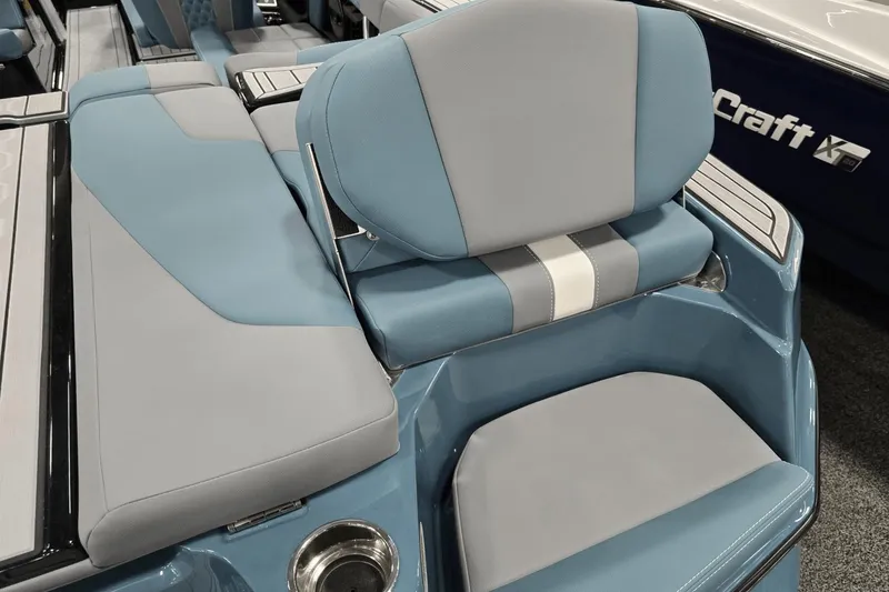 Slide: The Image of 2025 MasterCraft XT22 T boat interior with blue and gray seating. - 14