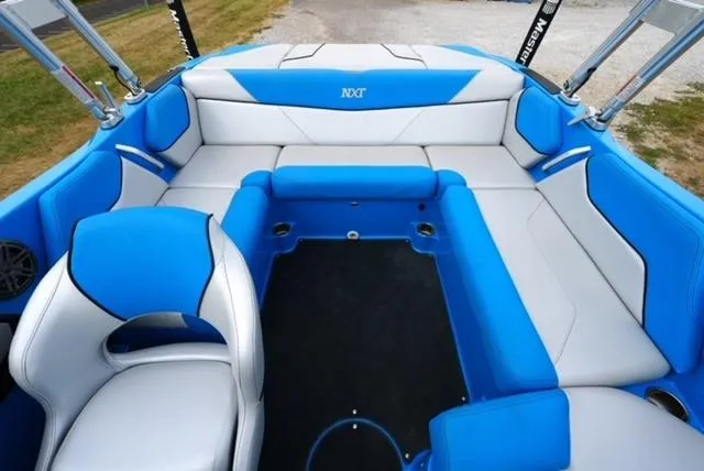 Slide: The Image of 2016 MasterCraft NXT20 boat interior with blue and white seating. - 13