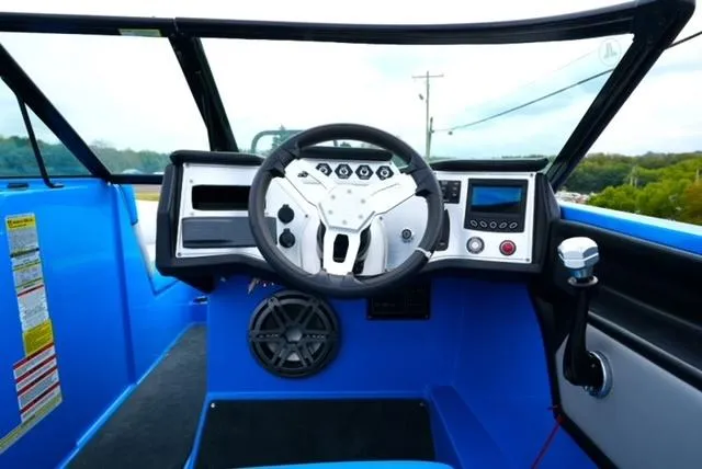 Slide: The Image of 2016 MasterCraft NXT20 boat dashboard with steering wheel and control panel. - 14
