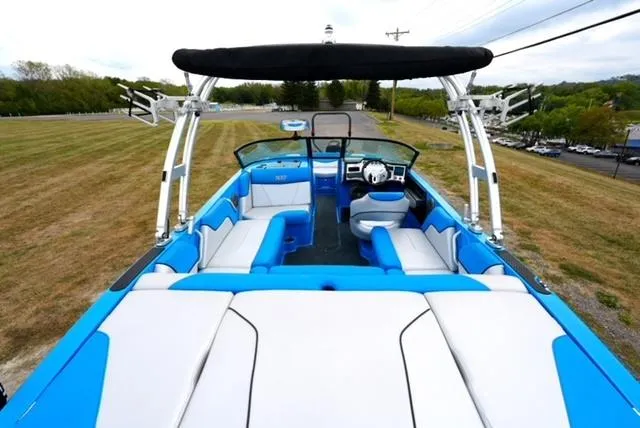 Slide: The Image of 2016 MasterCraft NXT20 boat with blue and white interior, open seating, and wakeboard tower. - 7