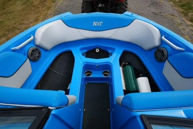 Slide: The Image of 2016 MasterCraft NXT20 boat interior with blue seating and storage compartments. - 9