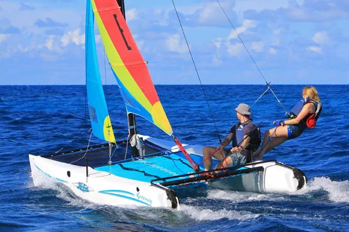 Slide: The Image of 2024 Hobie Cat Getaway sailing on blue ocean with two people onboard. - 4