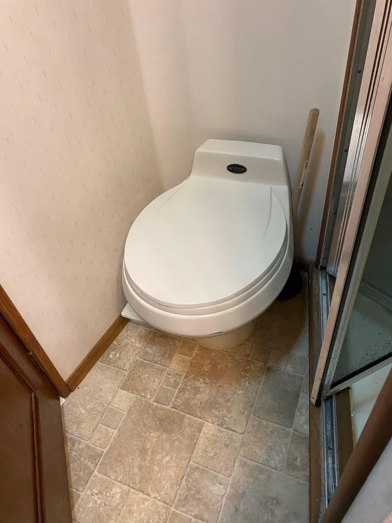 Slide: The Image of 1990 Viking 38 Convertible boat bathroom with compact toilet. - 11