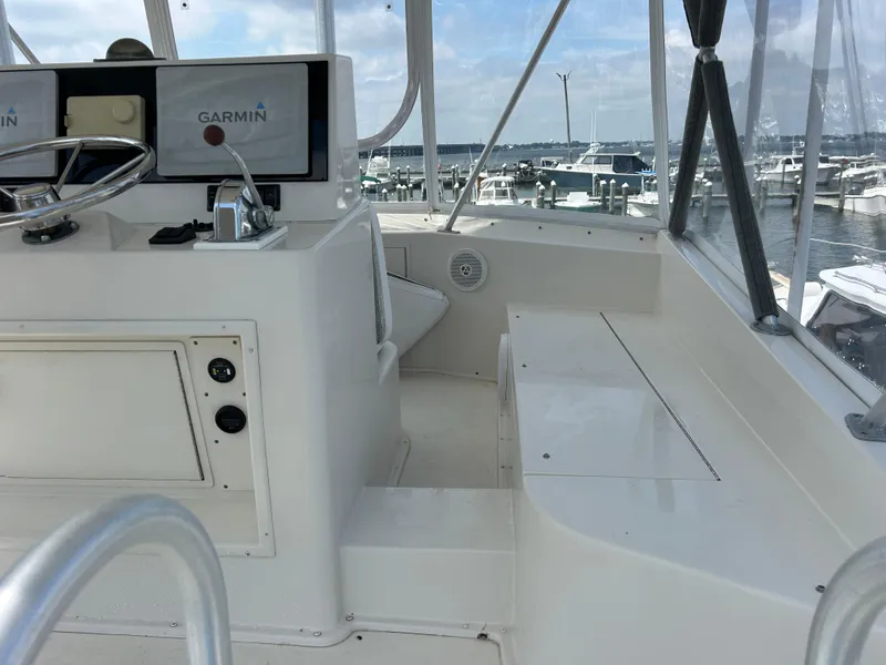 Slide: The Image of 1990 Viking 38 Convertible boat helm with Garmin navigation, docked at marina. - 15