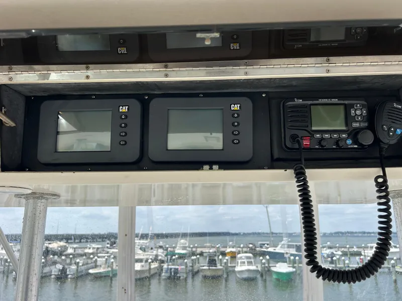 Slide: The Image of Control panel of a 1990 Viking 38 Convertible boat with harbor view. - 18