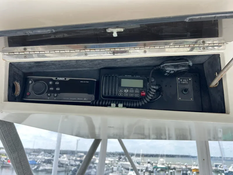 Slide: The Image of Control panel of a 1990 Viking 38 Convertible boat with radio and light switch. - 19