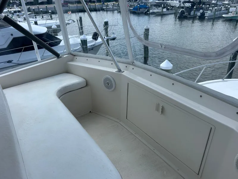 Slide: The Image of 1990 Viking 38 Convertible boat interior with seating, docked at marina. - 20